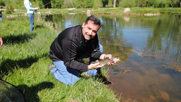 a man sitting in front of a lake